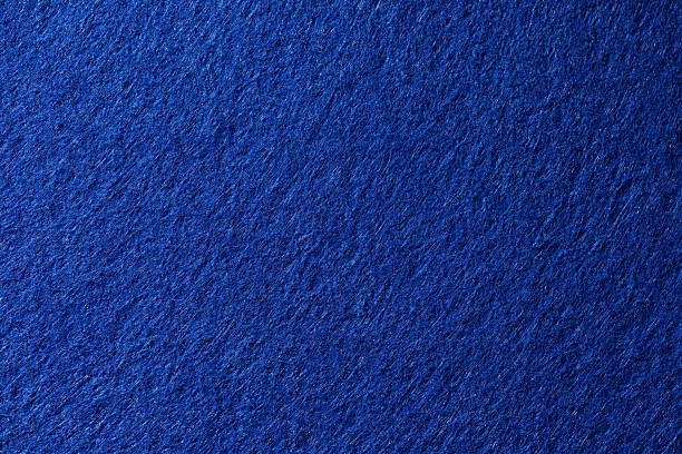 Macro image of blue felt fabric showing soft fibers and fuzzy surface texture.