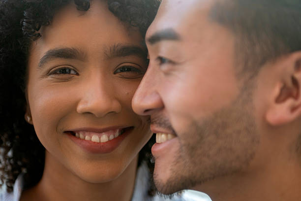 istock Interracial couple smiling, sharing an intimate, loving moment 2240851346