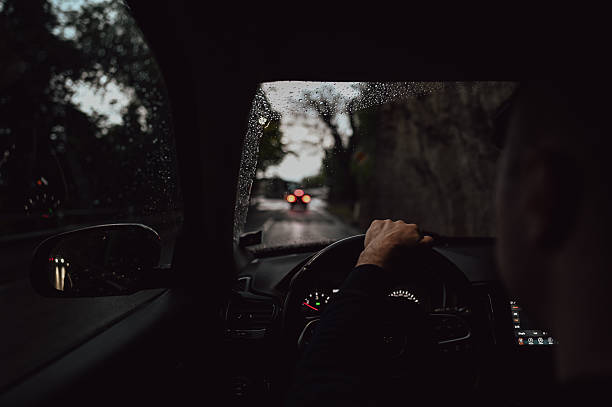 istock Driving car on rainy road at twilight 2240852794