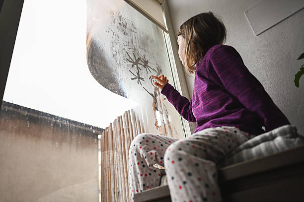 istock Child drawing spiders on condensed window on rainy day 2240852866