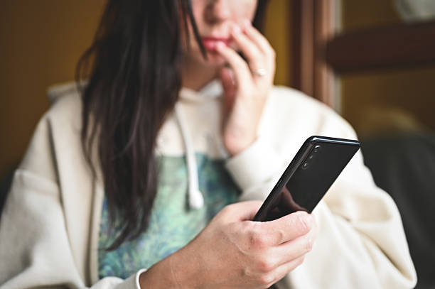 istock Woman feeling anxiety while checking social media on phone 2240852887