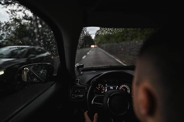 istock Driver steering car on a wet road in rain 2240852936