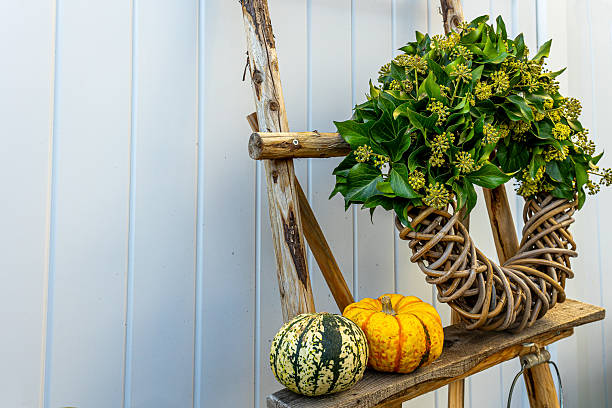istock Rustic autumn decoration with ivy wreath and pumpkins 2240854072