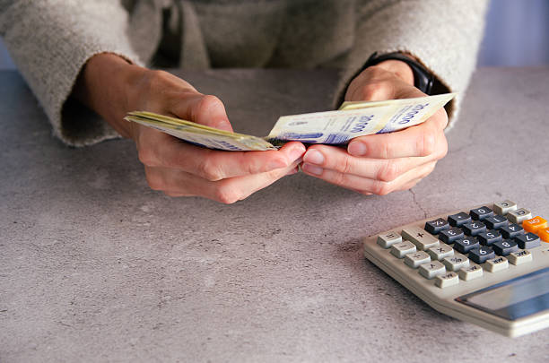 istock A woman counting Argentinian pesos. 2240857307