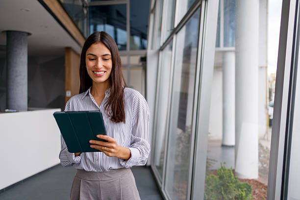 istock Smiling businesswoman using digital tablet in modern office, embracing technology for corporate communication and success 2240861222