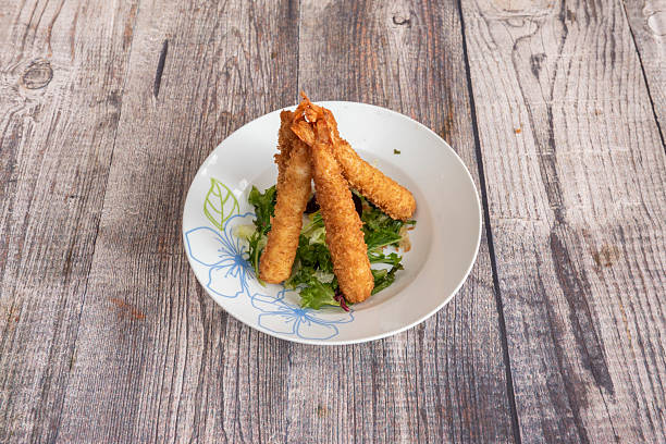 istock fried prawns battered with panko on lettuce and a plate from a Chinese restaurant 2240862853