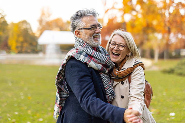 istock Cheerful couple dancing in autumn park, laughter shared 2240865010