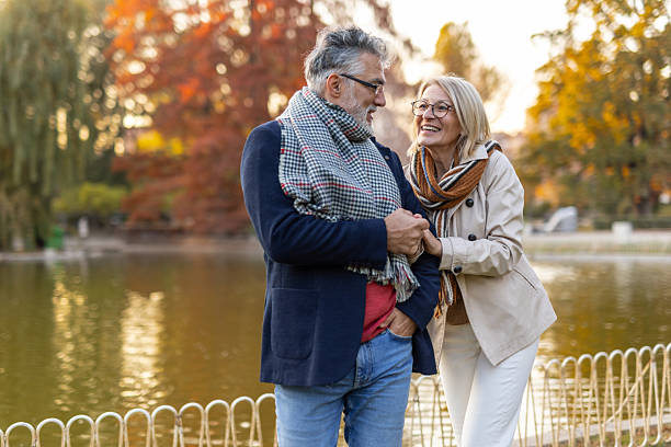 istock Couple sharing a laugh while enjoying the park scenery 2240865025