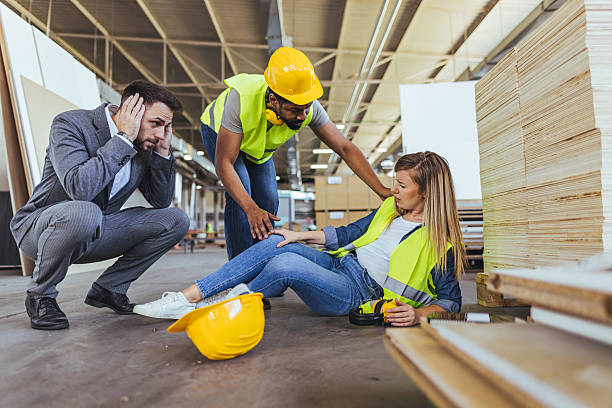 istock Workplace Accident Assistance with Concern from Coworkers in Factory Setting 2240865443