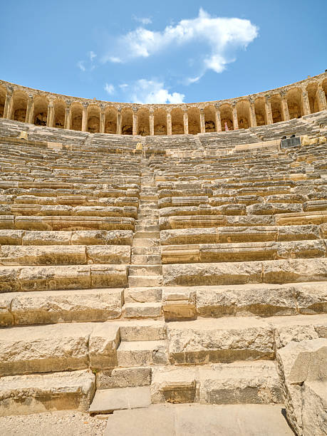 The historic Aspendos ruin and theater in Southern Turkey presents its fascinating architecture. The stone rows and arched design reveal a captivating glimpse into the artistry of ancient civilizations.