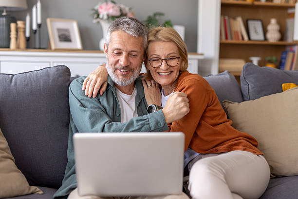 istock Elderly Couple Enjoying a Fun Moment on Their Sofa 2240867523