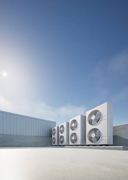 istock 3D rendering of air condenser on concrete floor with clear sky in background. Technology for climate control in building. Visuals related to HVAC engineering and building utility management. 2240873686