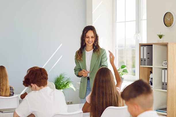 istock School happy teacher and students learning in classroom, asking pupils at desk 2240881201