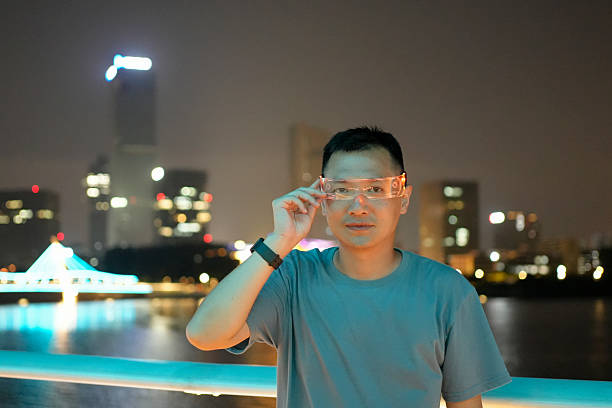 Under the night sky, a man uses smart glasses to turn on virtual reality