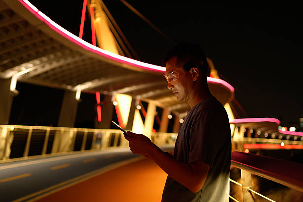 istock A man wore smart glasses at night and used a tablet computer by the river 2240885105