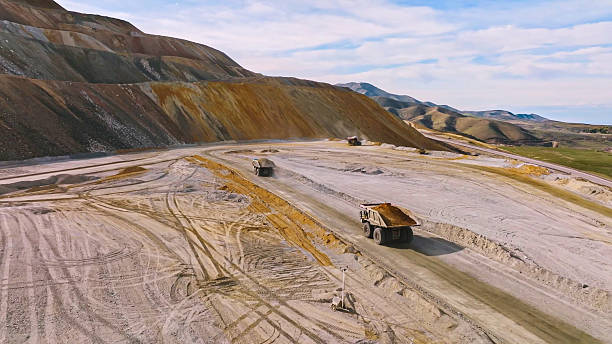 istock Process of transporting and dumping excavated mine material into leaching pads 2240888048