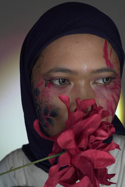 istock Dark floral face paint and dramatic red makeup 2240892661
