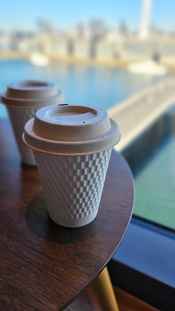 istock Drinking Freshly Brewed Americano Hot Coffee in Eco-Friendly takeout Paper Cup While Overlooking City Skyline and Tokyo Bay from Skyscraper, Afternoon Leisure and Sightseeing Experience in Japan 2240892744