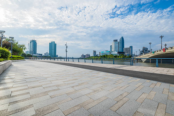 istock Empty waterfront promenade with a modern city skyline and bridge along the river in Ningbo. 2240893316