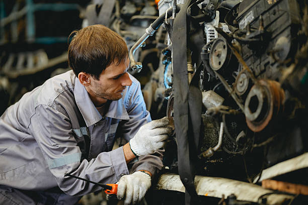 istock Maintenance engineer inspecting rust oily auto motor old spare part in junkyard for reuse service 2240893826
