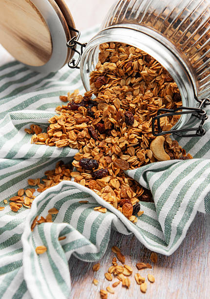 istock Granola pouring from jar on striped cloth 2240899451