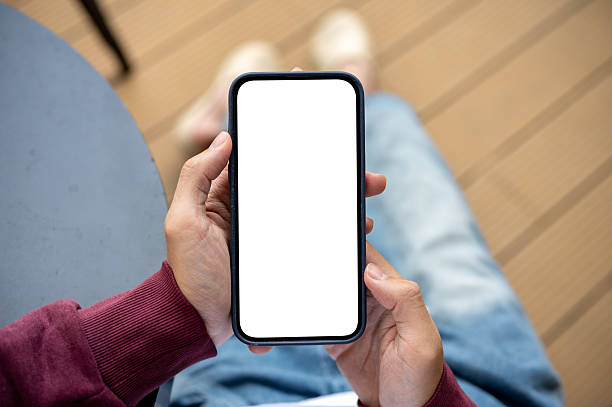 istock A man's hands holding white screen smartphone on black table look or read while sitting in the cafe. 2240903245