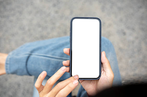 istock A man's hand holding and touching on white screen smartphone while sitting on bench at the sidewalk. 2240903293