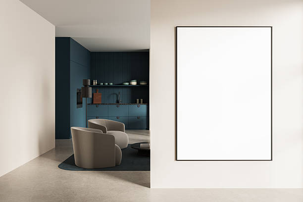 istock Modern interior with large vertical poster mockup on beige wall next to stylish kitchen and lounge area with armchairs and dark blue cabinetry. 3D Rendering 2240906869
