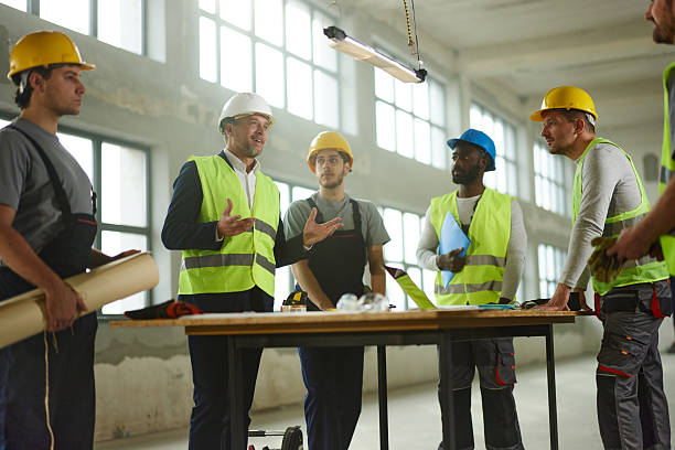 istock Male architect having a meeting with his workers at construction site. 2240908578