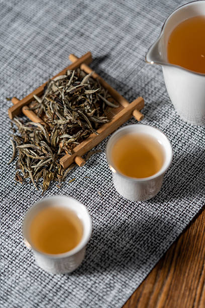istock Teapot, teacup, and tea placed on the desktop 2240908584