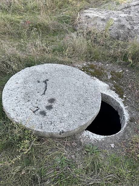 istock Open manhole with concrete cover on the park 2240908687