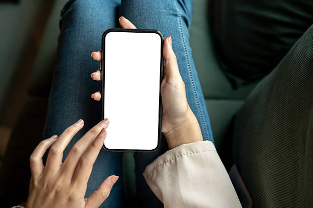 istock Close up woman hands touching blank screen smartphone while sitting on green sofa in cafe or lounge. 2240909004