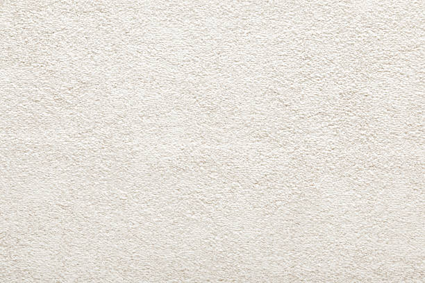White new fluffy home carpet background. Closeup. Empty place for text. Top down view.