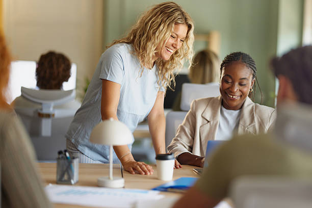 istock Happy creative women working on laptop in the office. 2240909622