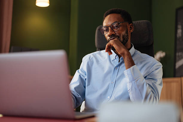 istock Adult man working on laptop in modern office, thinking 2240909969
