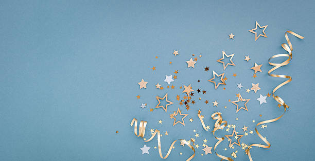 istock New Year, Christmas or birthday blue festive background top view. Celebration composition with golden confetti stars and serpentine party streamers. 2240910220