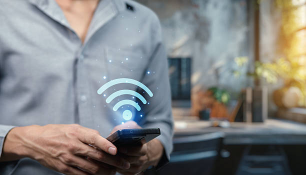 istock Wireless Signal Icon with Smartphone in Modern Office 2240911497
