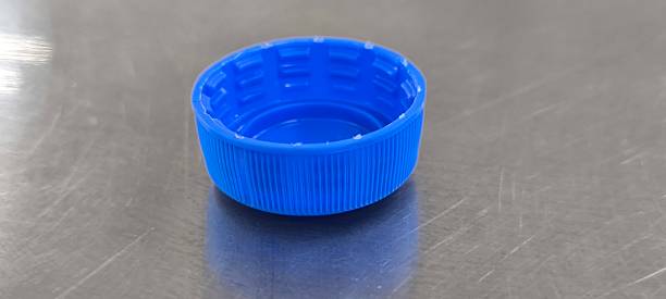 istock Blue soda bottle caps on a stainless steel table 2240912107