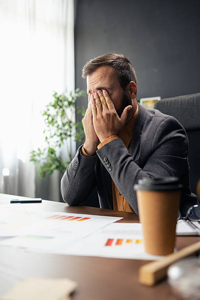 istock Businessman rubbing eyes feeling tired from office stress 2240913990