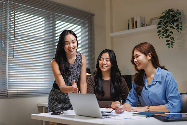 istock Asian businesswomen collaborating on project in office 2240914667