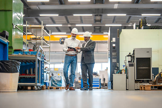 istock Caucasian Engineer and Hispanic Manager Collaborating in Industrial Factory 2240916553