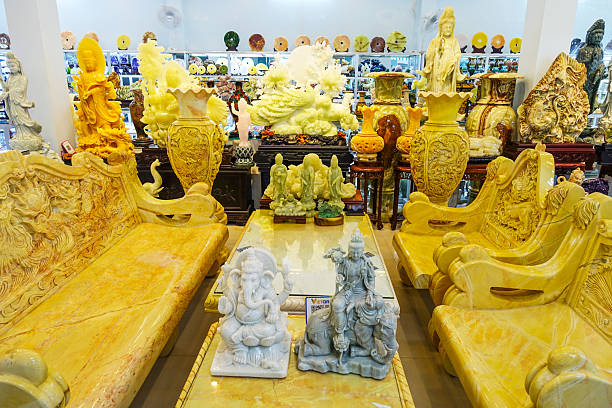 A high-end jewelry shop window in Dubai showcases gleaming gold rings, bracelets, and necklaces on plush display stands. The opulent arrangement emphasizes luxury, wealth, and fashion, inviting shoppers to explore premium craftsmanship.