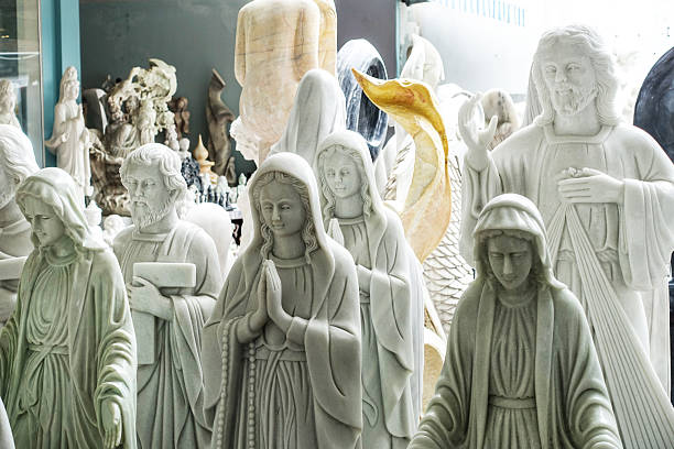 White marble statues of different religion and culture in the Vietnamese manufactory. Ceramics factory in Ha Long Bay Vietnam surrounded by white Marble dust. Hanoi to Halong Bay Route. Da Nang, Vietnam , July 2025.
