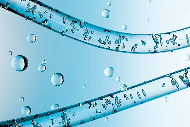 istock 3d abstract macro image of water drops inside transparent tubes on a blue background. Clean, fresh and futuristic design concept for purity, hydration and science themes. 2240922825