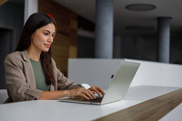 istock Business woman typing on laptop at work, performing tasks and improving workflow in modern office 2240924088