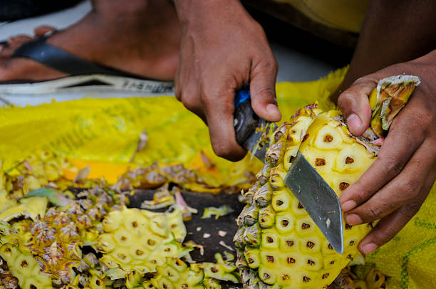 istock Skillfully Peel and Prepare a Ripe Yellow Pineapple 2240926363