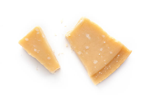 Parmesan cheese piece, cut,isolated on a white background, overhead flat lay shot