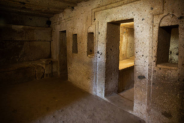 View of the Inside of Etruscan necropolis of Cerveteri (Banditaccia), an ancient burial site dating back to the 9th–3rd century BC. The archaeological area features grass-covered tomb mounds and rock-cut chambers, representing one of the most important remains of the Etruscan civilization in central Italy.