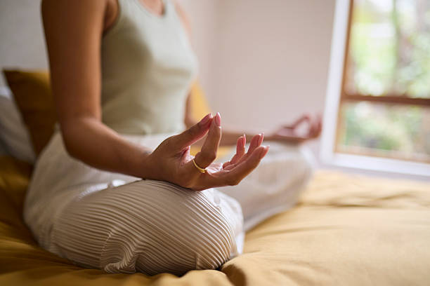 istock Close-up of Woman's Hand in Meditation Mudra Pose on Bed 2240927747