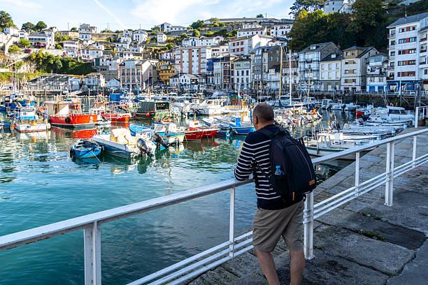 istock Man with backpack walking in the harbor admiring the panoramic view 2240929349